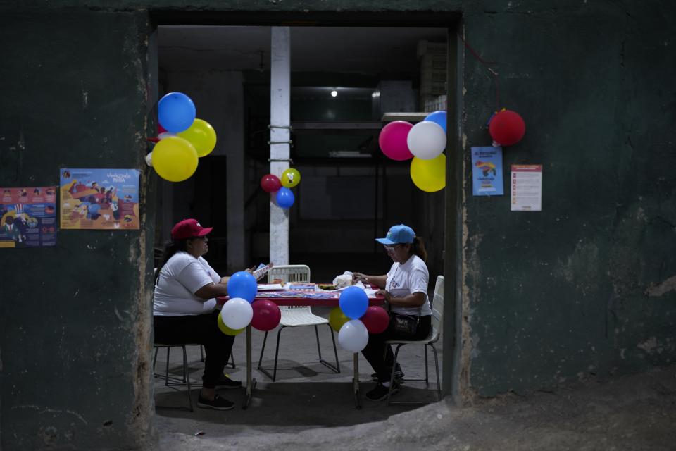 Ruling party grassroots organizers known as "Community Leaders" sort documents and propaganda about the Essequibo region, during a referendum about the future of a disputed territory with Guyana, in Caracas, Venezuela, Sunday, Dec. 3, 2023. (AP Photo/Ariana Cubillos)