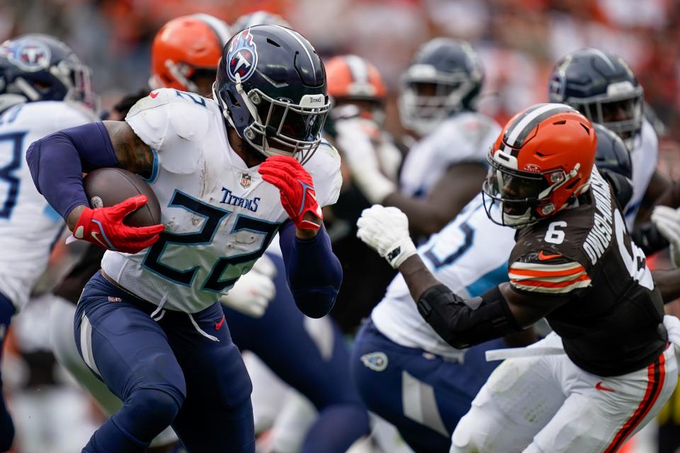 Tennessee Titans running back Derrick Henry (22) runs the ball past Cleveland Browns linebacker Jeremiah Owusu-Koramoah (6) during the third quarter in Cleveland, Ohio, Sunday, Sept. 24, 2023. (Andrew Nelles / The Tennessean / USA TODAY NETWORK)