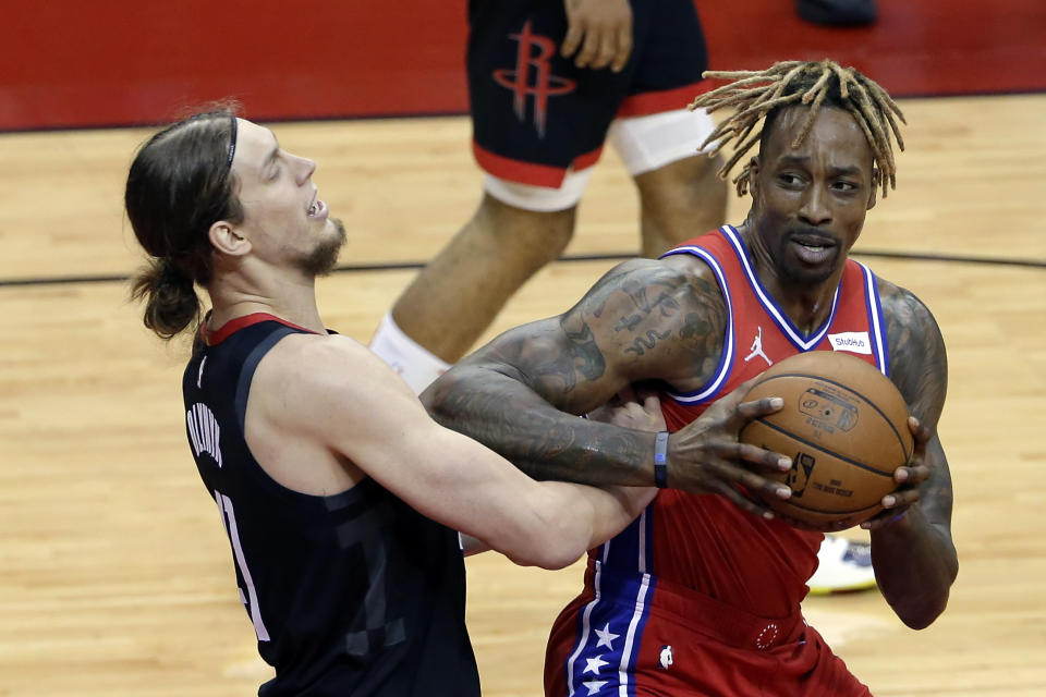 Houston Rockets forward Kelly Olynyk, left, takes an elbow from Philadelphia 76ers center Dwight Howard, right, as he looks for a shot during the first half of an NBA basketball game Wednesday, May 5, 2021, in Houston. (AP Photo/Michael Wyke, Pool)