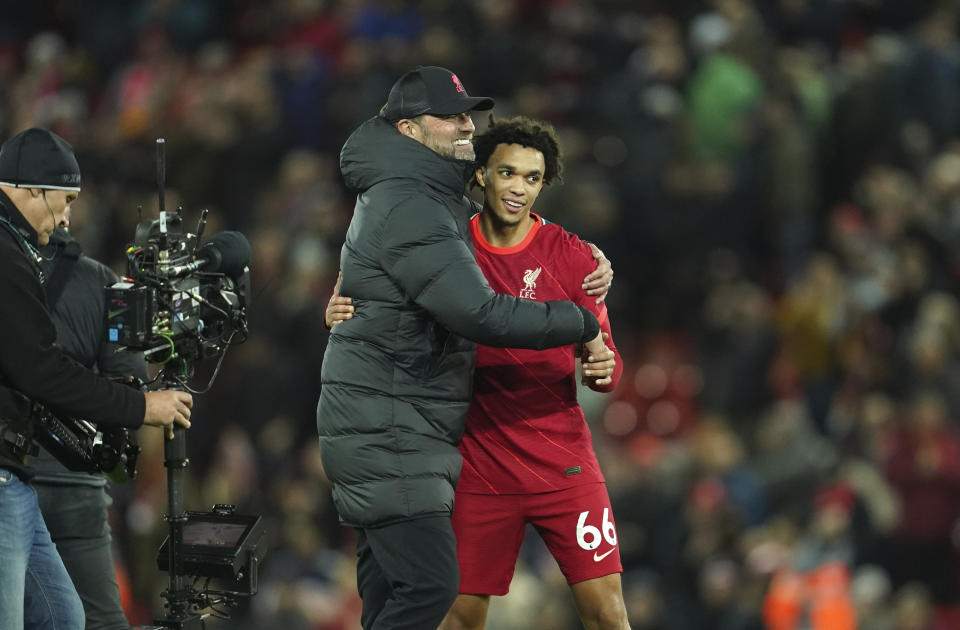 Liverpool's manager Jurgen Klopp celebrates with Liverpool's Trent Alexander-Arnold at the end of the English Premier League soccer match between Liverpool and Arsenal at Anfield Stadium, Liverpool, England, Saturday, Nov. 20, 2021. (AP Photo/Jon Super)