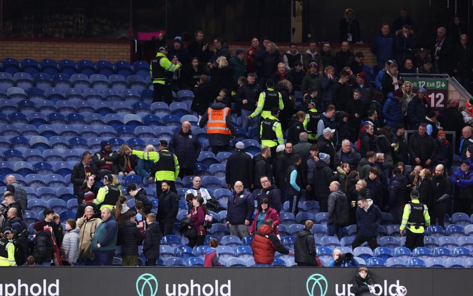 Police and stewards escort fans away from an area of the stand, due to an issue with the stadium roof during the Premier League match between Burnley FC and Wolverhampton Wanderers