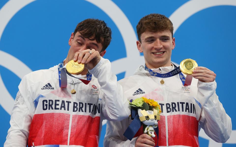 Tom Daley brushes away a tear while Matty Lee is all smiles on the podium - Clive Rose/Getty Images