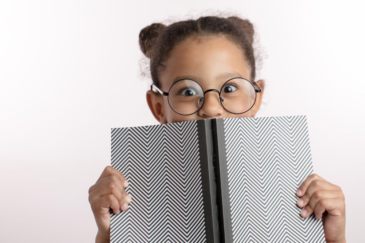 Wanting your child to do well is understandable but pushing too hard could affect their mental health. Girl with book. (Getty Images)