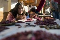 A buyer looks at rubies in the gems market in Mogok, Myanmar