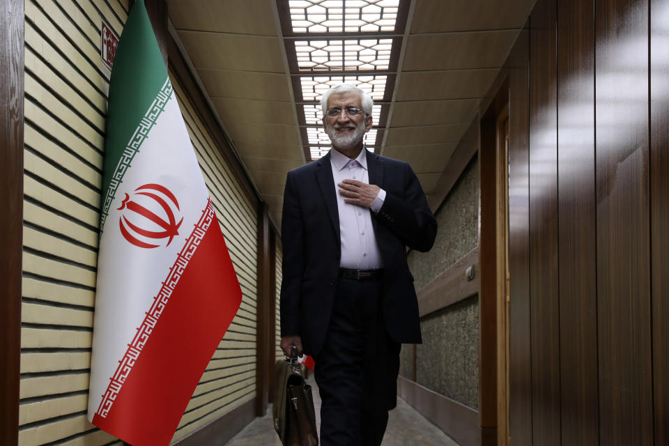 In this picture made available by Iranian state-run TV, IRIB, presidential candidate for June 28, election Saeed Jalili, former Iran's top nuclear negotiator, arrives for a debate of the candidates at the TV studio in Tehran, Iran, Thursday, June 20, 2024. (Morteza Fakhri Nezhad/IRIB via AP)