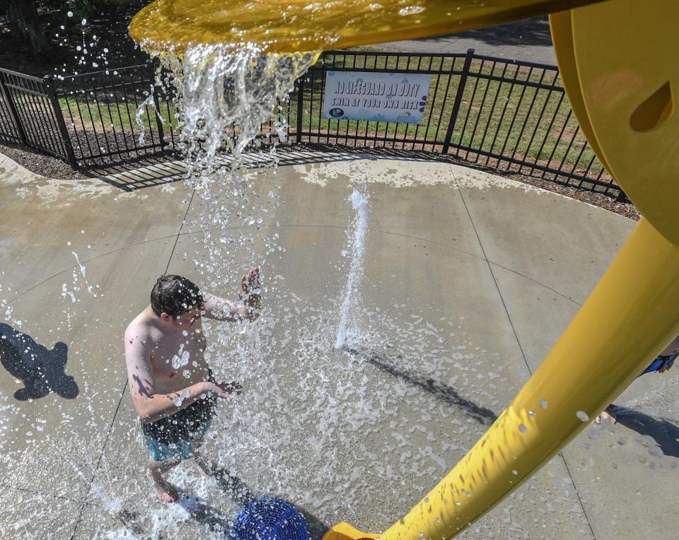 Leif Chapman of Anderson stands under a splash of water at the KidVenture2 splash pad at the Anderson Sports and Entertainment Complex in Anderson, S.C. Friday, June 21, 2024.