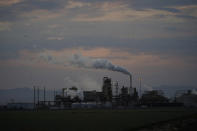 The exterior of the Cal Energy Elmore geothermal power plant is shown near the Sonny Bono Salton Sea National Wildlife Refuge Thursday, July 15, 2021, in Calipatria, Calif. Demand for electric vehicles has shifted investments into high gear to extract lithium from geothermal wastewater around California's dying Salton Sea. The ultralight metal is critical to rechargeable batteries. Despite widespread availability in the United States, Nevada has the country's only lithium plant, and U.S. production lags far behind Australia, Chile, Argentina and China. California's largest but rapidly shrinking lake is at the forefront of efforts to make the U.S. a major global player, though decades of economic stagnation and environmental ruin have left some residents on its receding shores indifferent or wary. (AP Photo/Marcio Jose Sanchez)