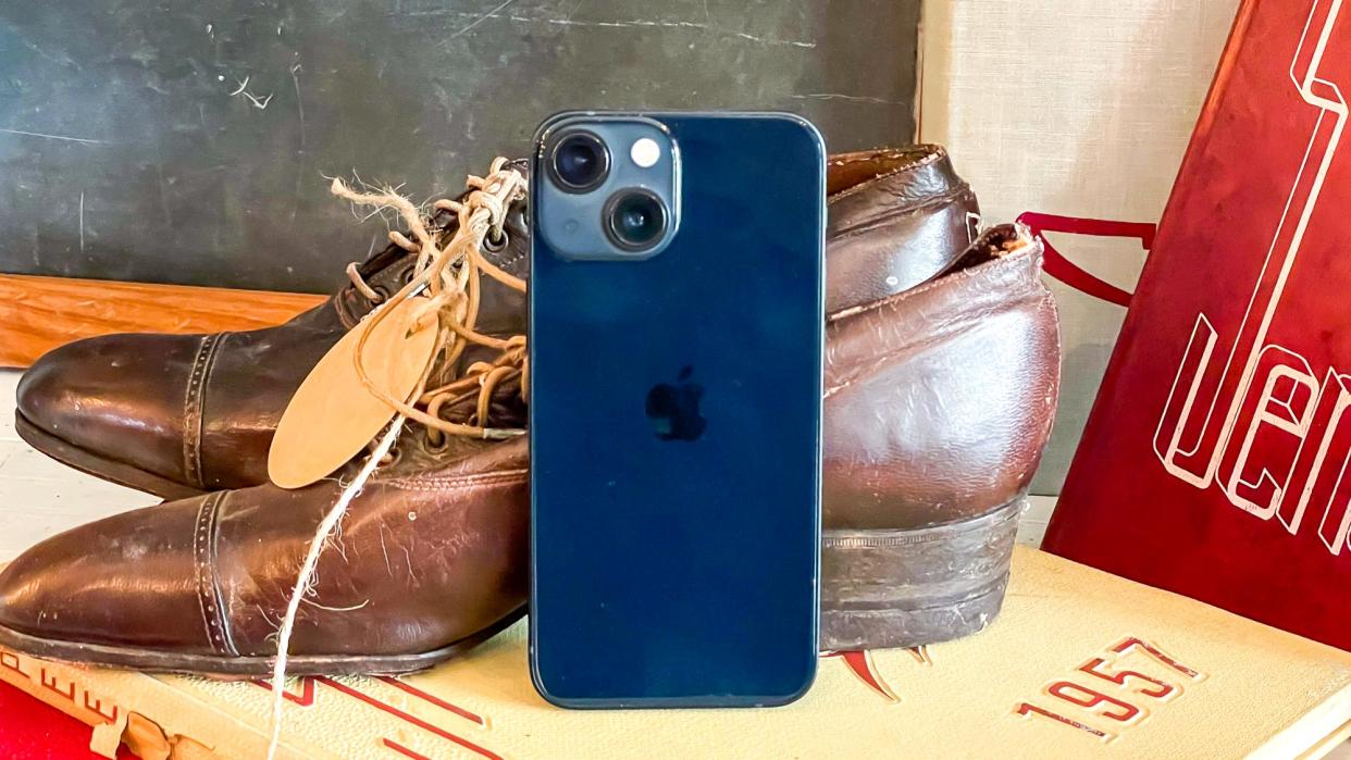  iphone 13 mini leaning against vintage shoes 