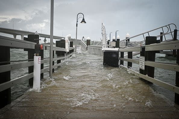 TOPSHOT - A boardwalk at the Clearwater Harbor Marina in Clearwater, Florida, is flooded by the rising tide on August 30, 2023, after Hurricane Idalia made landfall. Idalia barreled into the northwest Florida coast as a powerful Category 3 hurricane on Wednesday morning, the US National Hurricane Center said. 