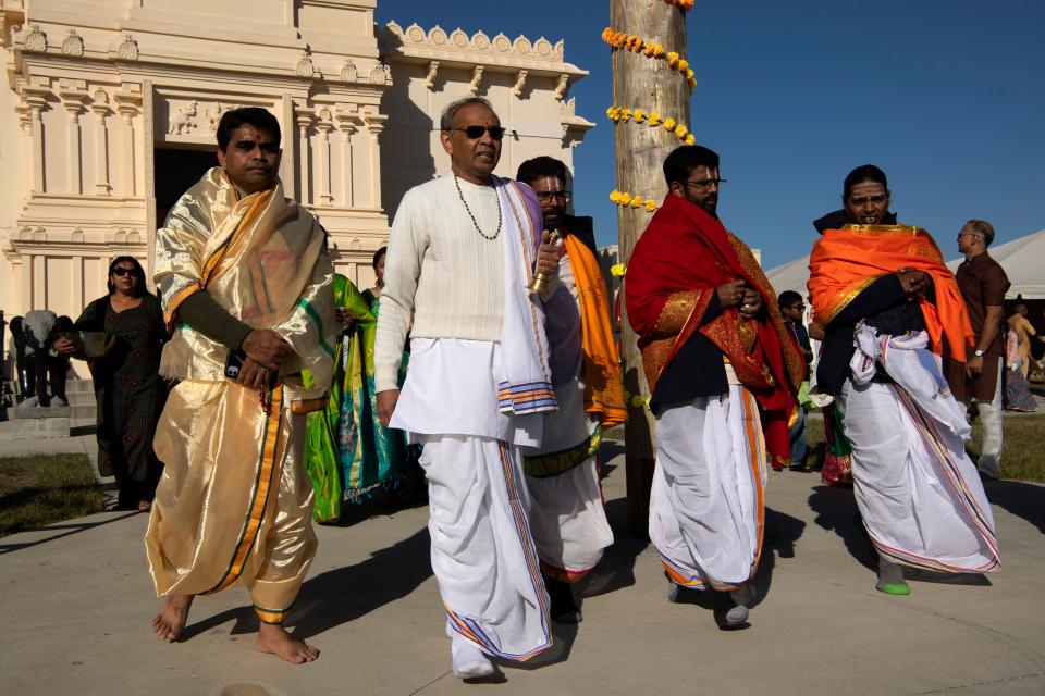 Surendra Mishra, temple priest at the Tri-State Hindu Temple, far left, and other visiting priests begin the 3-day Prana Pratishtha festival for the blessing of the temple in Newburgh, Ind., Friday morning, Oct. 14, 2022. The ceremony involves inviting the deities to live inside the temple to bring it to life.