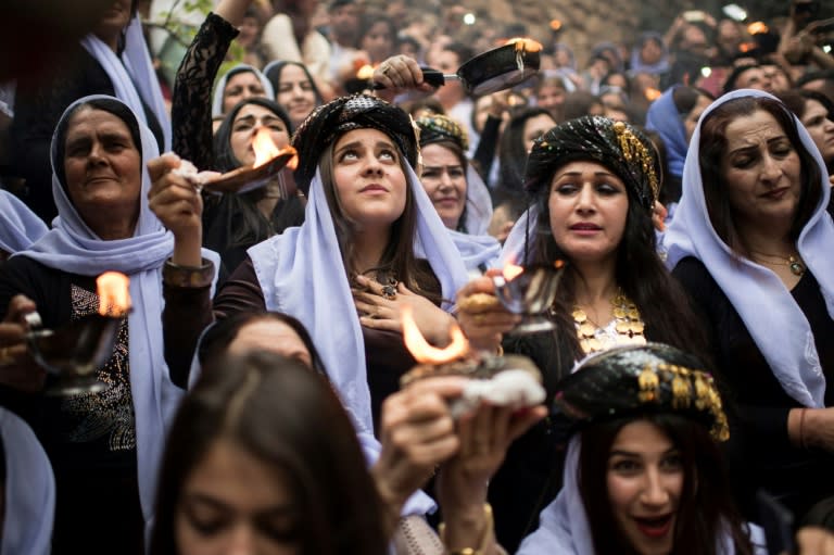 Iraqi Yazidis light candles and paraffin torches outside Lalish temple, the holiest shrine of their faith, during a ceremony on April 18, 2017 to mark the eve of Yazidi New Year