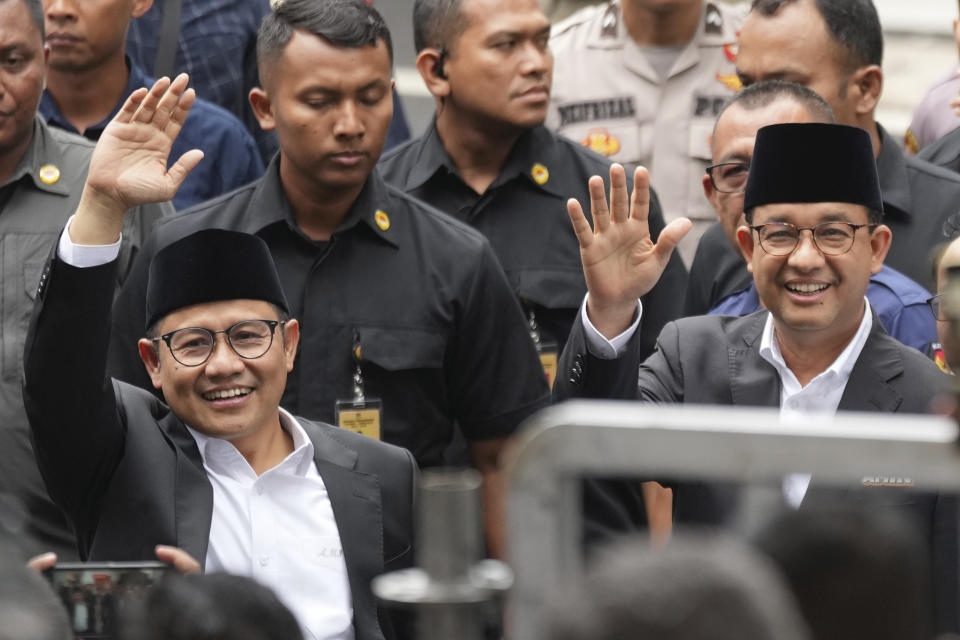 Presidential candidate Anies Baswedan, right, and his running mate Muhaimin Iskandar, left, wave at photographers as they arrive to attend the "Declaration of Peaceful Election Campaign" at the General Election Commission Building, in Jakarta, Indonesia, Monday, Nov. 27, 2023. Presidential candidates in the world's third-largest democracy will kick off their campaign period on Nov. 28 ahead of the country's simultaneous legislative and presidential elections in February 2024. (AP Photo/Tatan Syuflana)