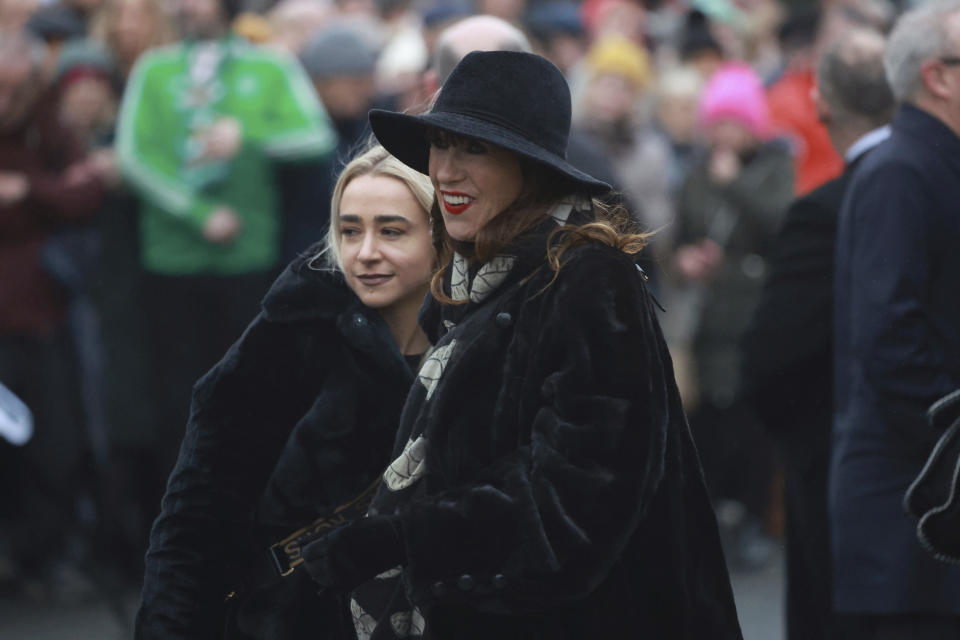 Victoria Mary Clarke, right, wife of Shane MacGowan, arrives for the funeral of Shane MacGowan at Saint Mary's of the Rosary Church, Nenagh, Ireland, Friday, Dec. 8, 2023. MacGowan, the singer-songwriter and frontman of The Pogues, best known for their ballad “Fairytale of New York,” died on Thursday, Nov. 30, 2023. He was 65. (Niall Carson/PA via AP)