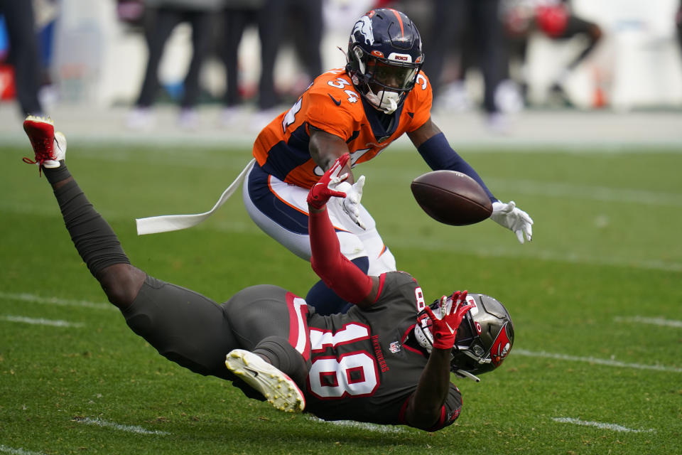 Tampa Bay Buccaneers wide receiver Tyler Johnson, below, can't make the catch as Denver Broncos defensive back Essang Bassey defends during the second half of an NFL football game Sunday, Sept. 27, 2020, in Denver. (AP Photo/Jack Dempsey)