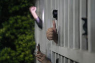 Supporters of of Apple Daily show signs to thank the reporters at the headquarters in Hong Kong, Thursday, June 24, 2021. Hong Kong's pro-democracy Apple Daily newspaper will stop publishing Thursday, following last week's arrest of five editors and executives and the freezing of $2.3 million in assets under the city's year-old national security law. (AP Photo/Kin Cheung)