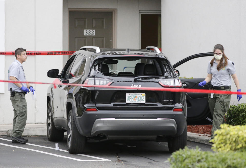 FILE -Forensic technicians work on the vehicle authorities say officers fired shots at, that breached security at President Donald Trump's Mar-a-Lago resort in Palm Beach, Florida. Friday, Jan. 31, 2020, in West Palm Beach, Fla. Two Florida sheriff's deputies were justified when they fired numerous shots at a Connecticut opera singer whose speeding SUV blasted through a checkpoint outside then-President Donald Trump's Mar-a-Lago almost four years ago, an internal affairs investigation concluded, Nov. 29, 2023. (AP Photo/Terry Renna, File)