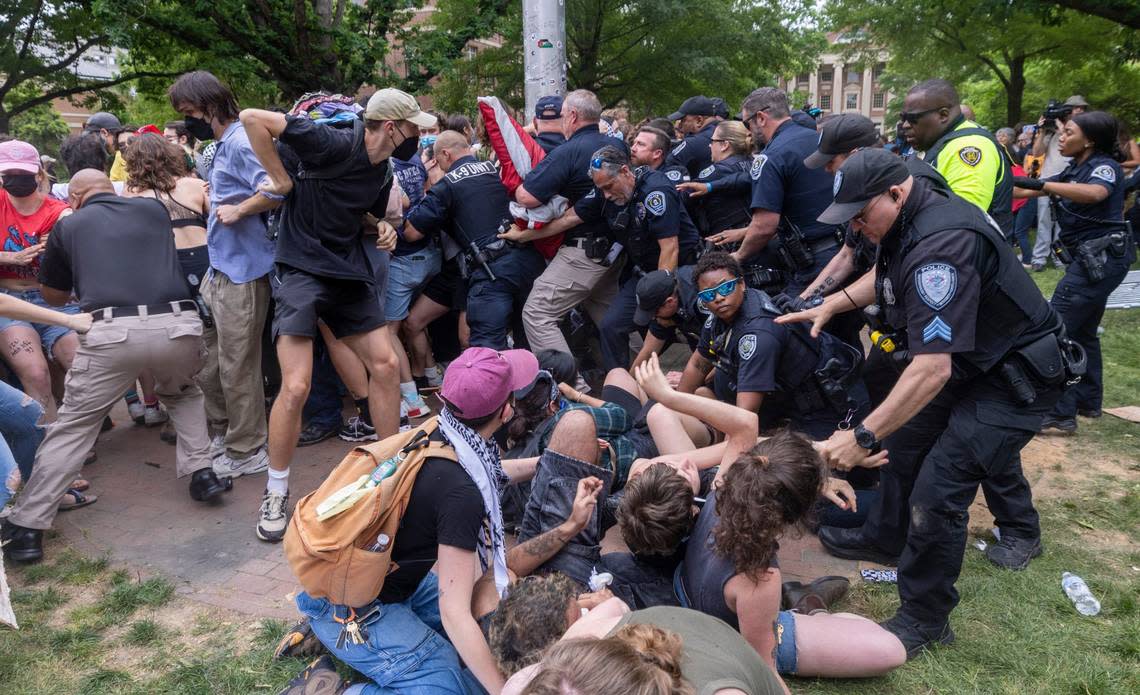 Pro-Palestinian demonstrators clash with police after replacing an American flag with a Palestinian flag Tuesday, April 30, 2024 at UNC-Chapel Hill. Police removed a “Gaza solidarity encampment” earlier Tuesday morning.