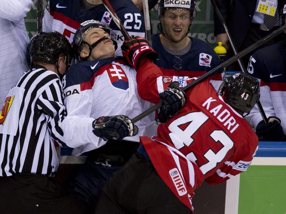 Canada's Nazem Kadri hits Slovakia's Marek Daloga with a high stick during second period action at the IIHF Ice Hockey World Championship in Minsk, Belarus, on Saturday, May 10, 2014. (AP Photo/The Canadian Press, Jacques Boissinot)