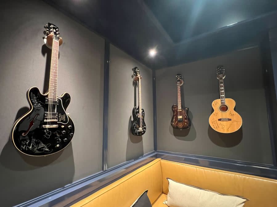 Guitars signed by artists who have performed on Austin City Limits TV show hang on a wall at Austin PBS. (KXAN Photo/Abigail Jones)