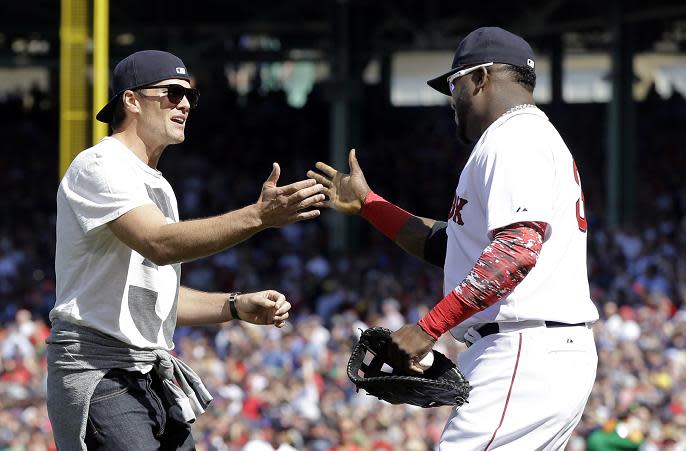 Tom Brady greets David Ortiz after throwing the ceremonial first pitch prior to the Red Sox home opener in 2015. (AP) 