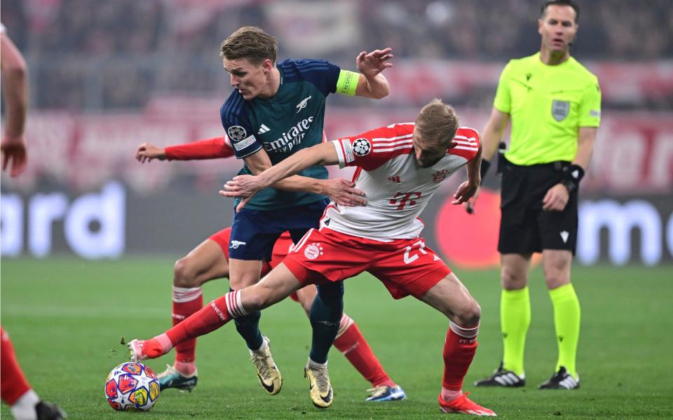 Konrad Laimer challenges Martin Odegaard.