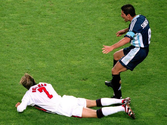 <p>Mark Leech/Offside/Getty</p> Diego Simeone reacts to David Beckham kicking out after a challenge during the 1998 FIFA World Cup.