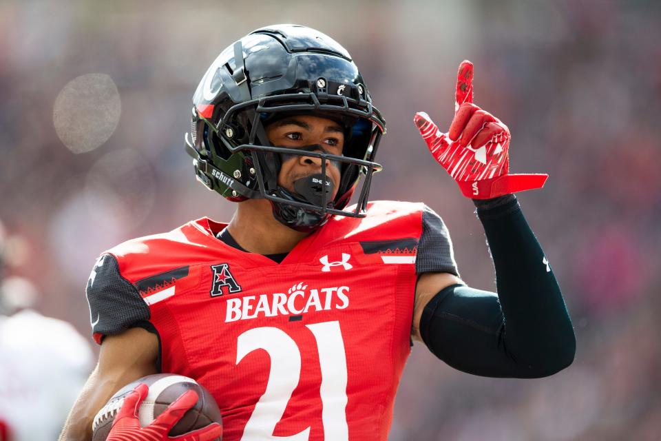 Cincinnati Bearcats wide receiver Tyler Scott (21) celebrates after scoring a touchdown during the first quarter of the NCAA football game between the Cincinnati Bearcats and the Indiana Hoosiers at Nippert Stadium, Saturday, Sept. 24, 2022.