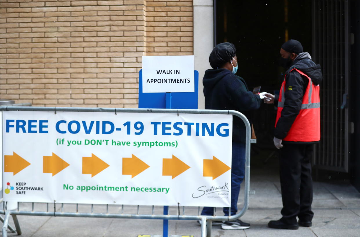 People stand outside a coronavirus disease (COVID-19) test centre at London Bridge Station, in London, Britain, April 5, 2021. REUTERS/Hannah McKay