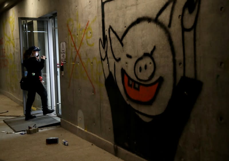 A person claiming to be a volunteer medic searches for anti-government protesters at the premises of Polytechnic University (PolyU) in Hong Kong