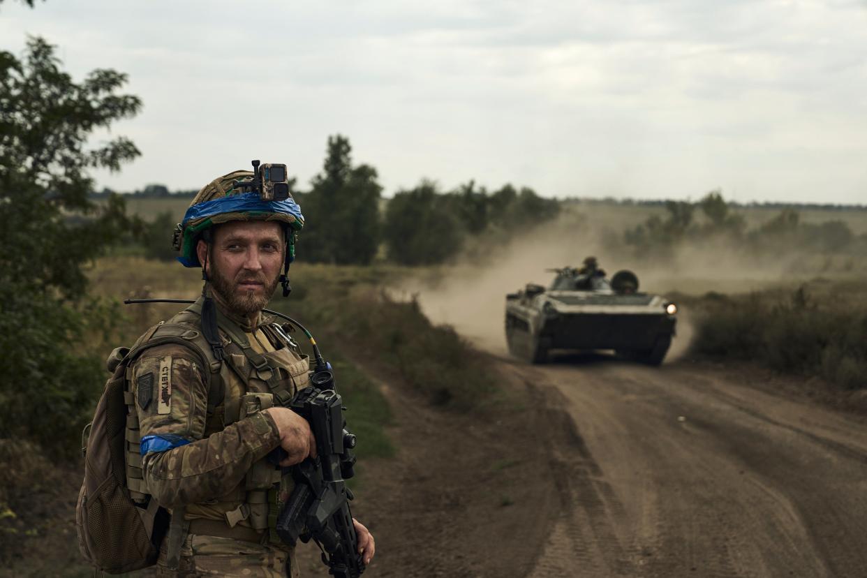 File photo: A soldier of Ukraine’s 3rd Separate Assault Brigade looks on against the background of an APC near Bakhmu (AP)