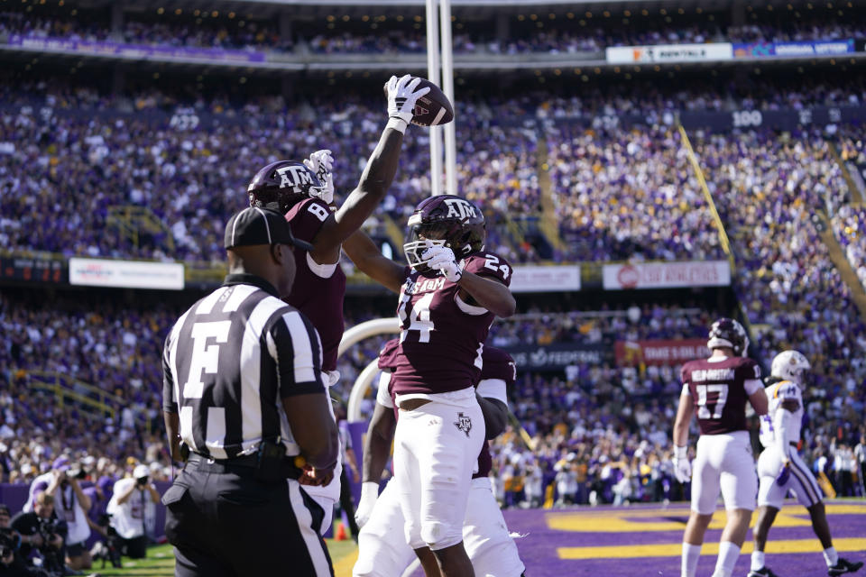 Texas A&M running back Le'Veon Moss (8) celebrates his touchdown carry with running back Earnest Crownover (24) in the first half of an NCAA college football game against LSU in Baton Rouge, La., Saturday, Nov. 25, 2023. (AP Photo/Gerald Herbert)