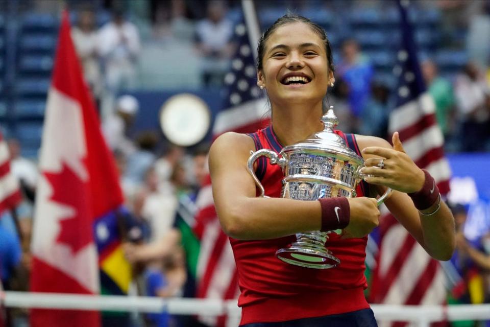 Emma Raducanu hugs the US Open championship trophy after her sensational victory (Elise Amendola/AP/PA Wire) (AP)