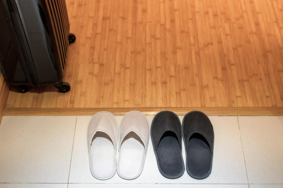 Two pairs of shoes in a hallway.