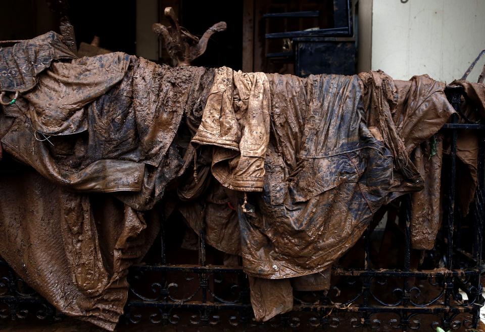 <p>Muddy clothes have been left on a fence of a house in Mandra, Western Attica, Greece, Nov. 16, 2017. (Photo: Yannis Kolesidis/EPA-EFE/REX/Shutterstock) </p>