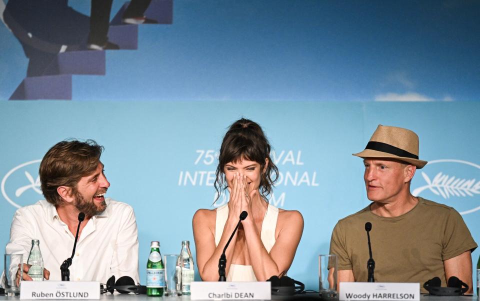 Swedish film director Ruben Ostlund, South African model and actress Charlbi Dean and US actor Woody Harrelson attend a press conference for the film "Triangle of Sadness" during the 75th edition of the Cannes Film Festival in Cannes, southern France, on May 22, 2022.