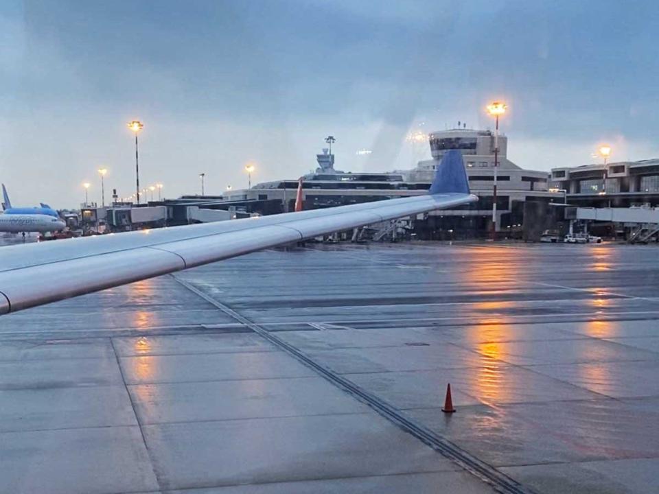 The wing of an airplane as viewed inside from a seat on the plane.