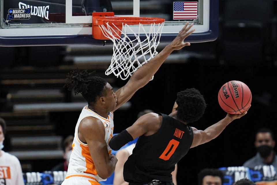 Tennessee guard Yves Pons, left, fouls Oregon State guard Gianni Hunt (0) during the first half of a first round game at Bankers Life Fieldhouse in the NCAA men's college basketball tournament in Indianapolis Friday, March 19, 2021. (AP Photo/Paul Sancya)