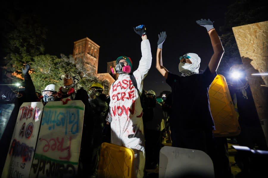 Pro-Palestinian students stand their ground after police breached their encampment at the campus of the University of California, Los Angeles (UCLA) in Los Angeles, California, early on May 2, 2024. (Photo by ETIENNE LAURENT/AFP via Getty Images)