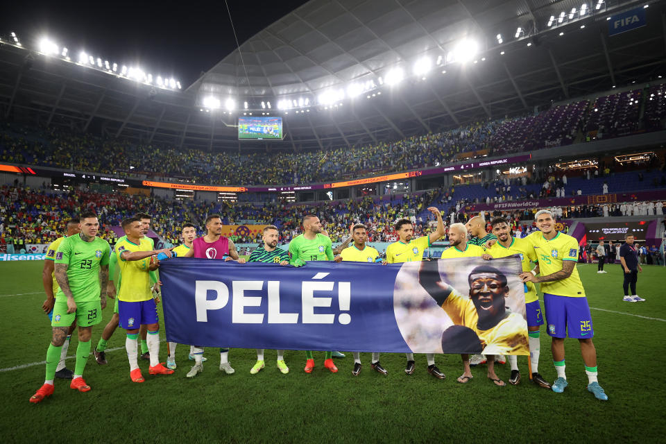 Brazil players hold a banner showing support for former Brazil player Pele after the World Cup match between Brazil and South Korea. (Hector Vivas/Getty Images)