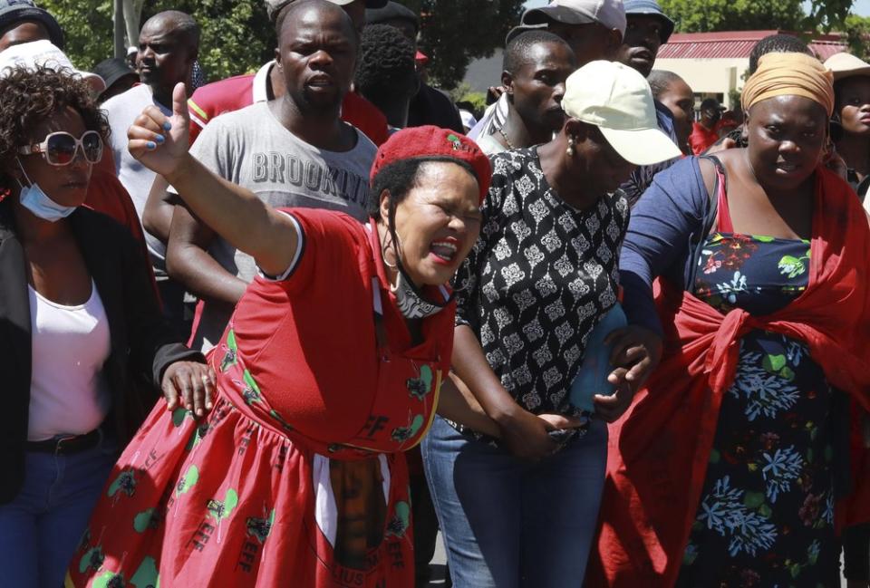 Members of the Economic Freedom Fighters (EFF) protest near the Brackenfell High school in Cape Town, South Africa, Friday, Nov. 20, 2020. (AP Photo/Nardus Engelbrecht)