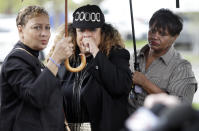 <p>A woman, center, who would only be identified as the godmother of shooting victim DeEbony Groves, cries as she listens at a news conference regarding the capture of Travis Reinking Monday, April 23, 2018, in Nashville, Tenn. Reinking, who police say shot and killed at least four people Sunday at a Waffle House restaurant, was captured Monday in a wooded area near his apartment complex and the restaurant. Groves, 21, was a student at Nashville’s Belmont University. (Photo: Mark Humphrey/AP) </p>