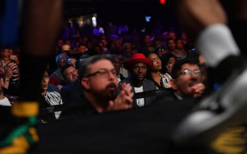  Professional boxer Floyd Mayweather Jr. (C) looks on during the junior middleweight bout between Nathaniel Gallimore and Julian Williams at The Joint inside the Hard Rock Hotel & Casino - Credit: Getty Images