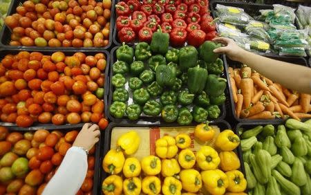 Customers select vegetables at a supermarket in Hanoi September 20, 2014. REUTERS/Kham