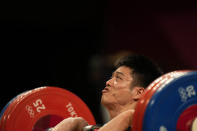 Li Fabin of China competes in the men's 61kg weightlifting event, at the 2020 Summer Olympics, Sunday, July 25, 2021, in Tokyo, Japan. (AP Photo/Luca Bruno)