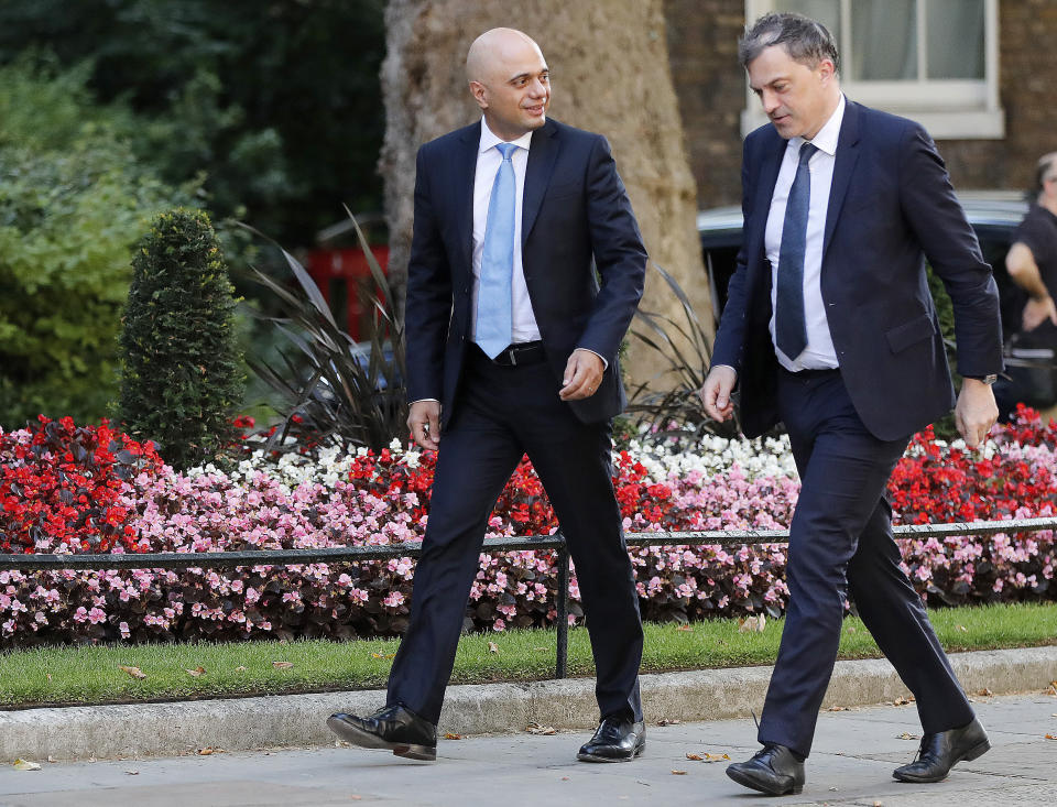 Britain's new Chancellor of the Exchequer Sajid Javid, left, and Northern Ireland Secretary Julian Smith arrive for a Cabinet meeting at 10 Downing Street in London, Thursday, July 25, 2019. Newly appointed Prime Minister Boris Johnson assembles members of his new Cabinet, meeting for the first time Thursday. (AP Photo/Frank Augstein)