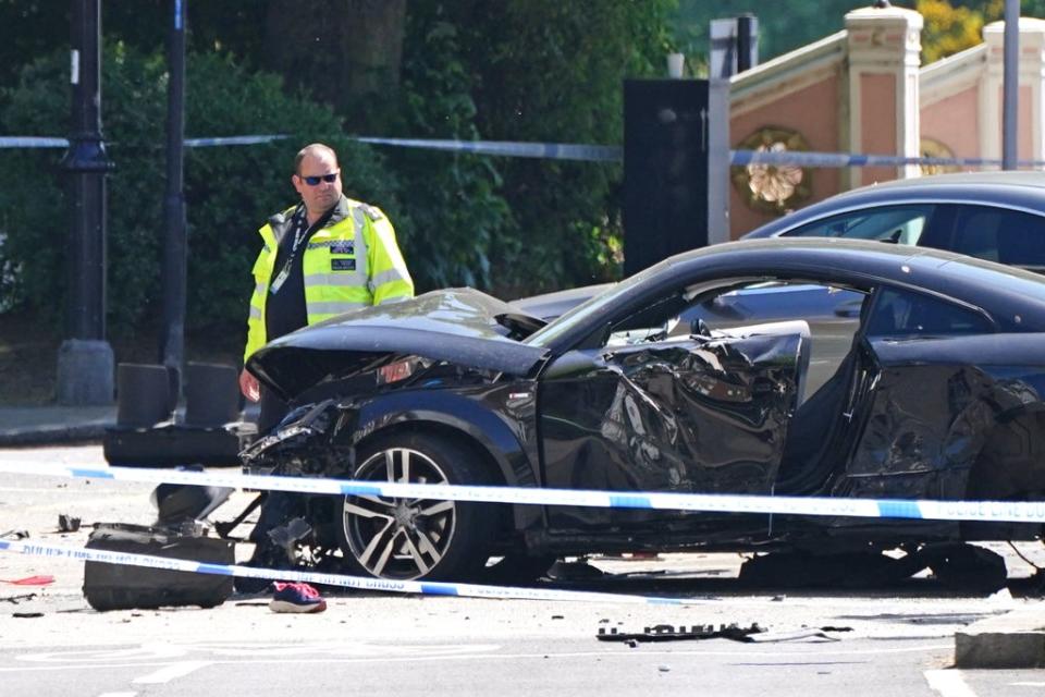 A police officer at the scene at Cheyne Walk in Chelsea, London, after a 41-year-old woman and three dogs have been killed following a car crash (PA)