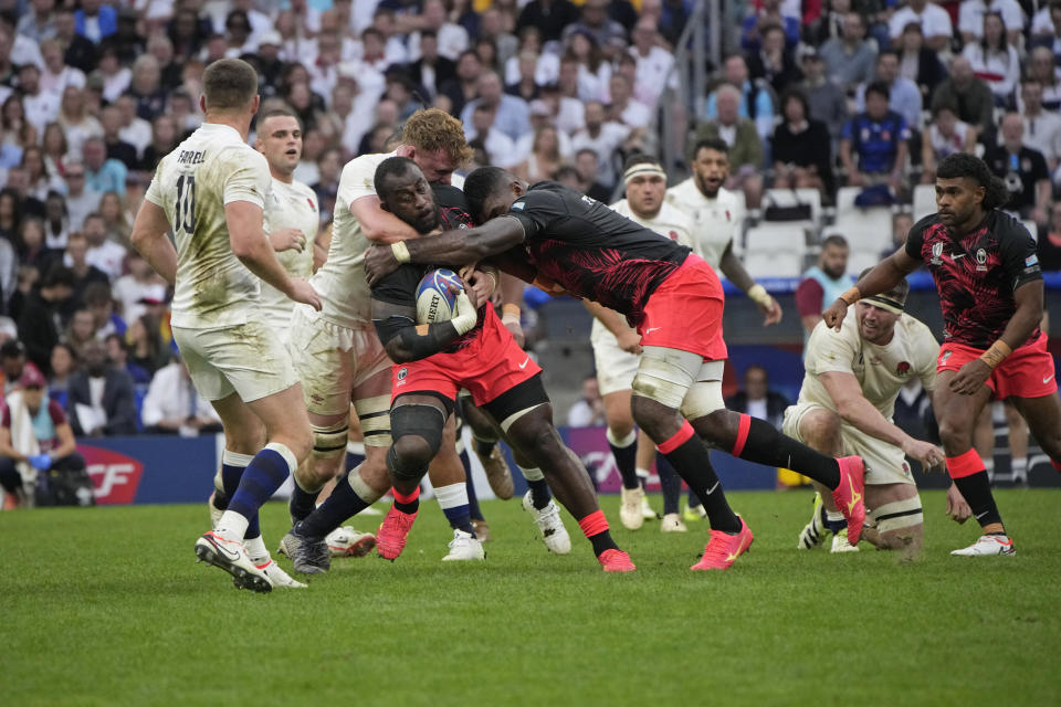 Fiji's Peni Ravai controls the ball during the Rugby World Cup quarterfinal match between England and Fiji at the Stade de Marseille in Marseille, France, Sunday, Oct. 15, 2023. (AP Photo/Laurent Cipriani)