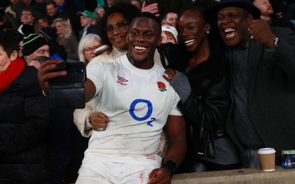 England's Maro Itoje poses for a selfie with family after the match