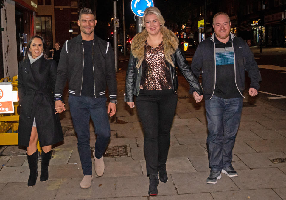 Strictly Come Dancing contestants Sara Davies (second right) and Aljaz Skorjanec (second left) with his wife Janette Manrara and Simon Davies (Sara's husband) walking on High St in London. Picture date: Friday October 29, 2021.