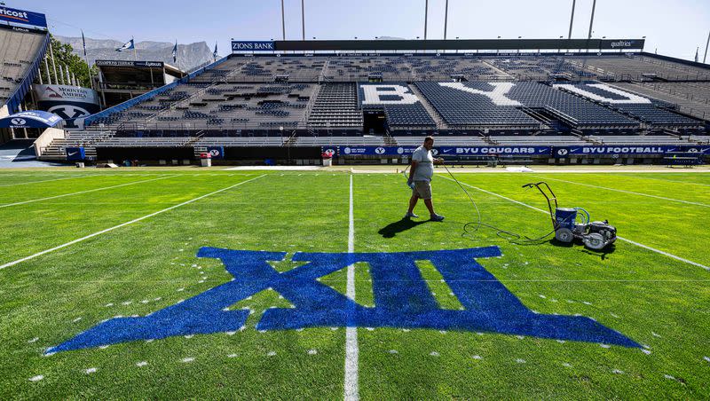 A member of the LaVell Edwards Stadium field crew checks out his handiwork Thursday, Aug. 31, 2023. The BYU football Big 12 era begins in earnest Saturday night when Sam Houston pays Provo a visit.